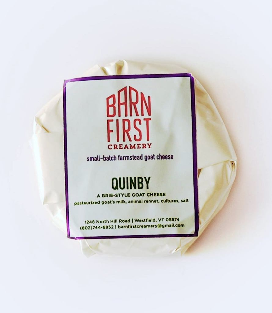 A package of Quinby brie-style goat cheese from Barn First Creamery, showcasing the label with product details and informational text.