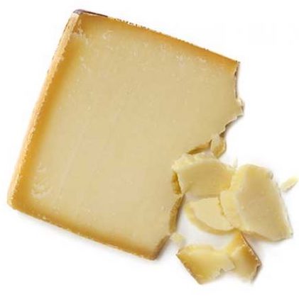A wedge of gruyere cheese with a few pieces broken off, on a white background.