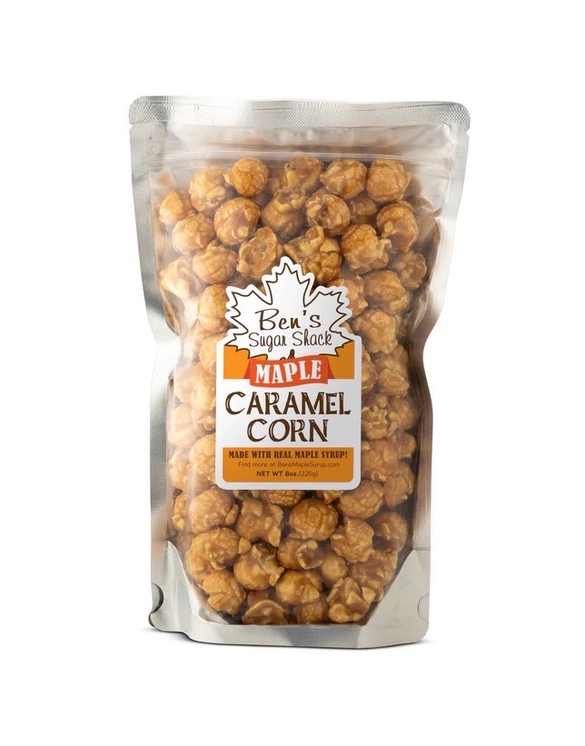 A clear bag filled with maple caramel corn, featuring a label that reads 'Ben's Sugar Shack Maple Caramel Corn, made with real maple syrup'.