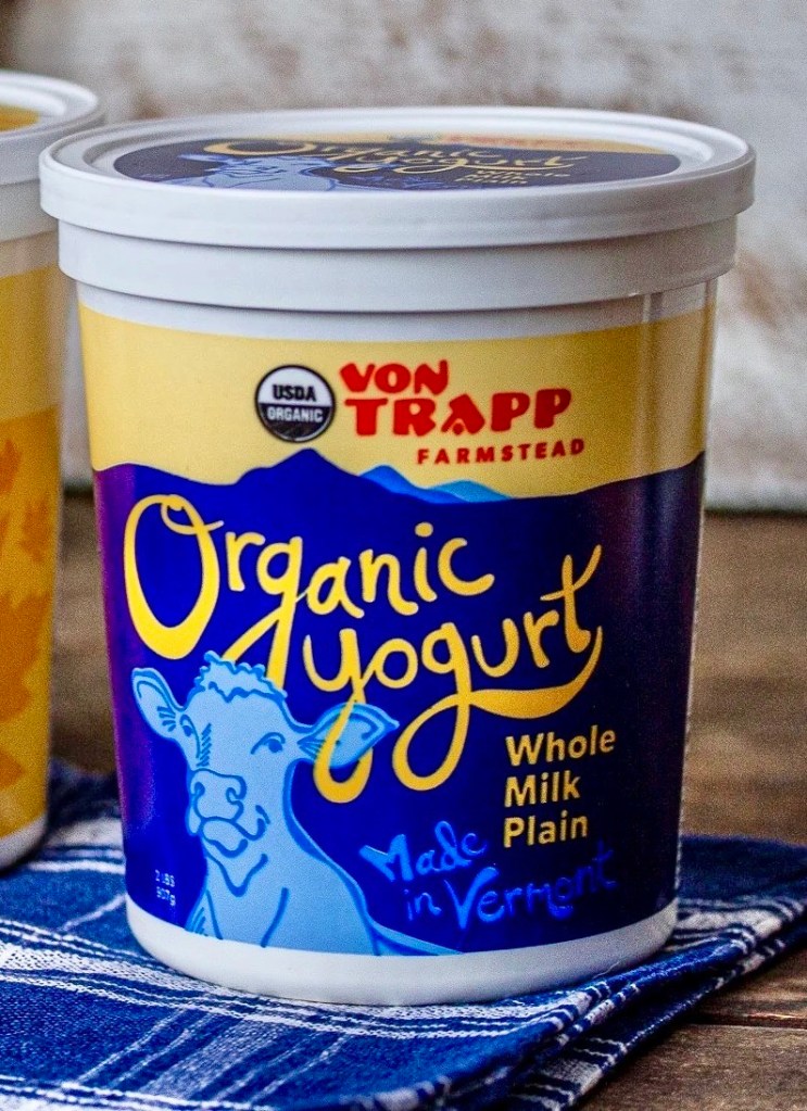 Container of Von Trapp Farmstead organic whole milk plain yogurt, displayed on a checkered cloth.