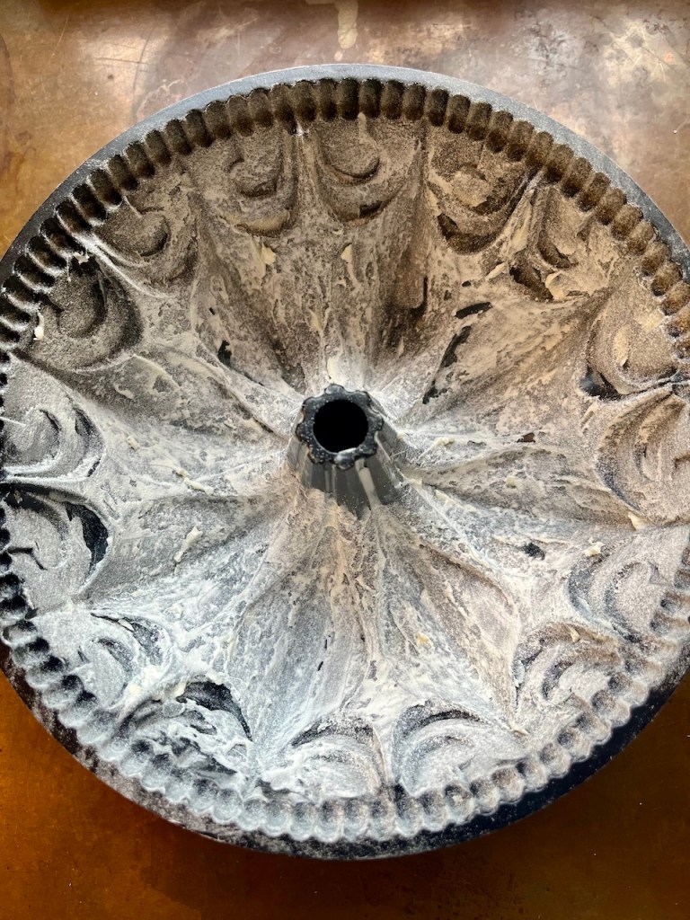 A heavily greased and floured bundt pan, ready for baking.
