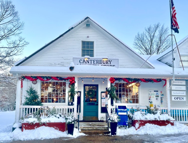 Exterior view of the Canterbury Country Store adorned with festive decorations and a snowy landscape.